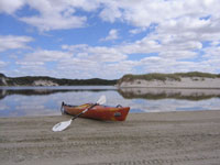 photo of kayak on beach inlet
